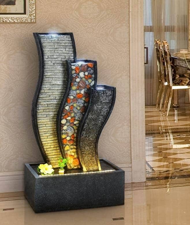 Modern Indoor Water Feature with Textured Stone and Pebbles