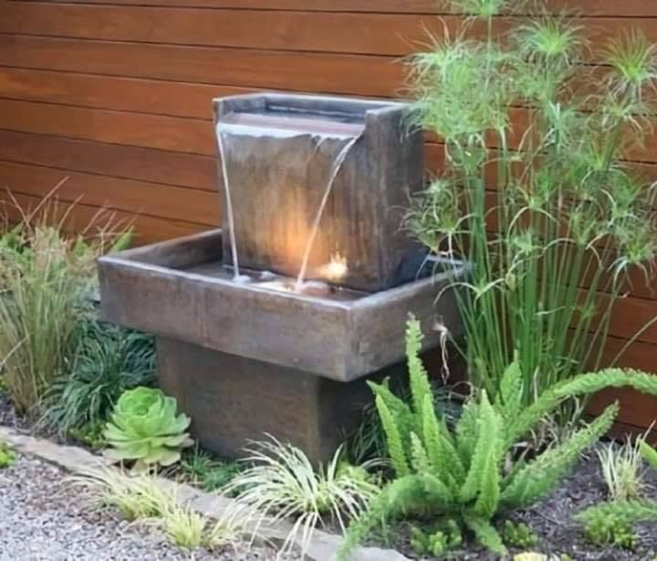 Modern Outdoor Water Feature with Lush Greenery