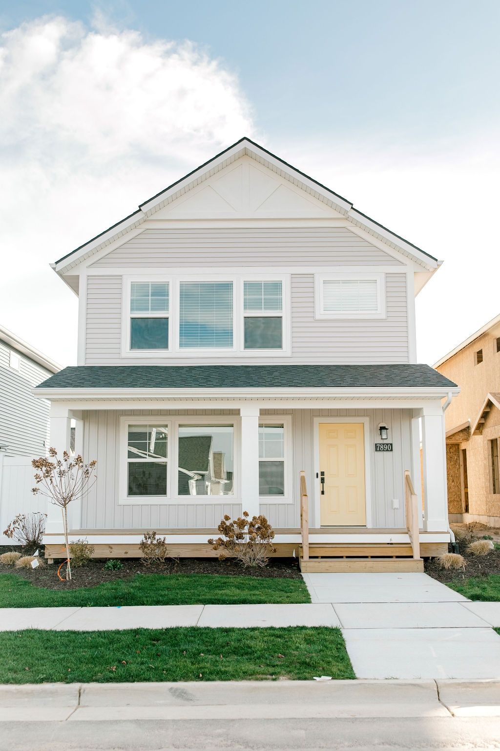 Modern Two-Story House Exterior with Light Gray Siding and Front Porch