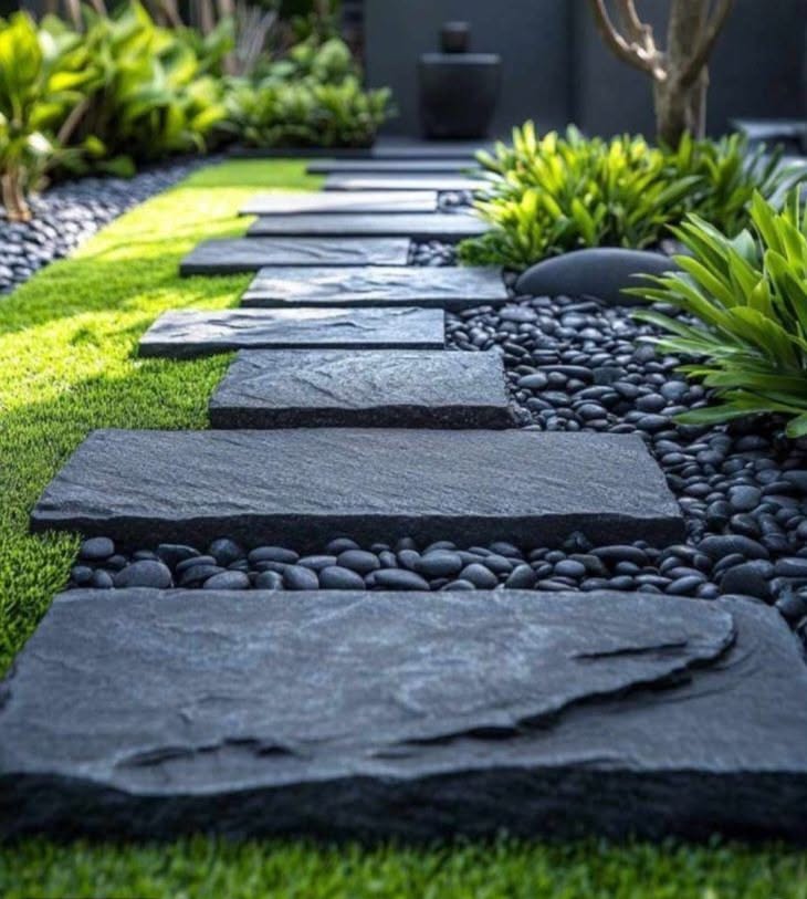 Modern Stone Garden Pathway with Black Pebbles and Lush Greenery