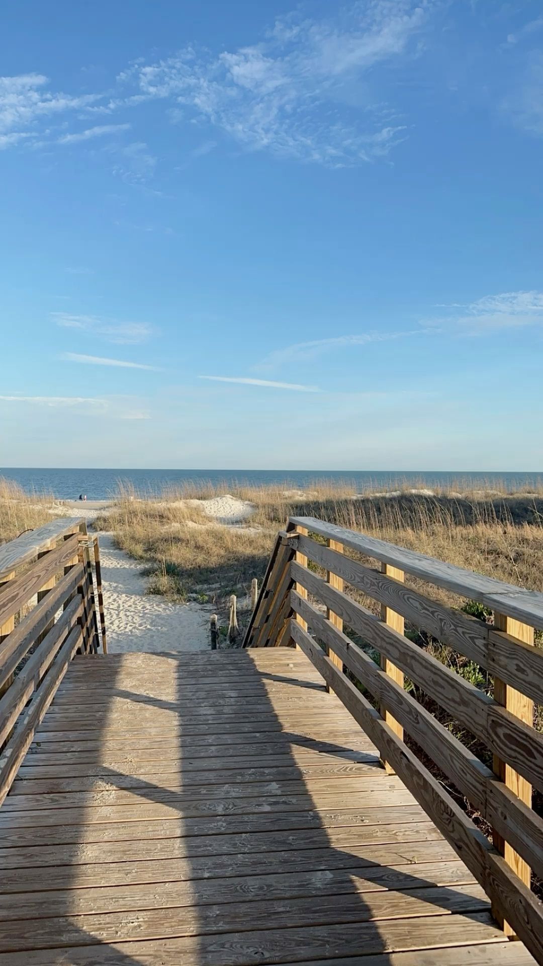 Scenic Wooden Walkway Leading to a Serene Beach